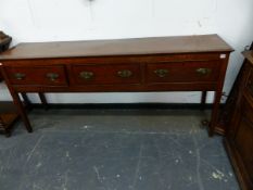 A LATE 18th.C.OAK DRESSER BASE WITH THREE DEEP DRAWERS ON INLAID SQUARE TAPERED LEGS. 180 x 42 x H.