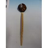 AN OTTOMAN SHERBET SPOON WITH COCONUT BOWL, THE DICED BONE HANDLE INSET WITH A CORAL CABOCHON