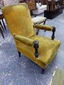 A VICTORIAN EBONISED WOOD ARMCHAIR UPHOLSTERED IN GOLDEN VELVET, THE HANDRESTS ON FLUTED COLUMNS.