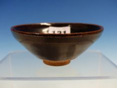 A HENAN GLAZED BOWL, THE RIM PALE BROWN IN CONTRAST TO THE TREACLE BROWN BODY. Dia. 10.5cms.