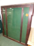 A LATE VICTORIAN MAHOGANY FRAMED GLAZED ROSETTE CABINET OR NOTICE BOARD WITH LOCKING CENTRAL DOOR.