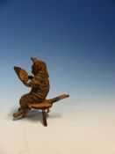 AN AUSTRIAN COLD PAINTED BRONZE FIGURE OF A CAT SEATED ON A STOOL READING PAPERS. H 5cms.