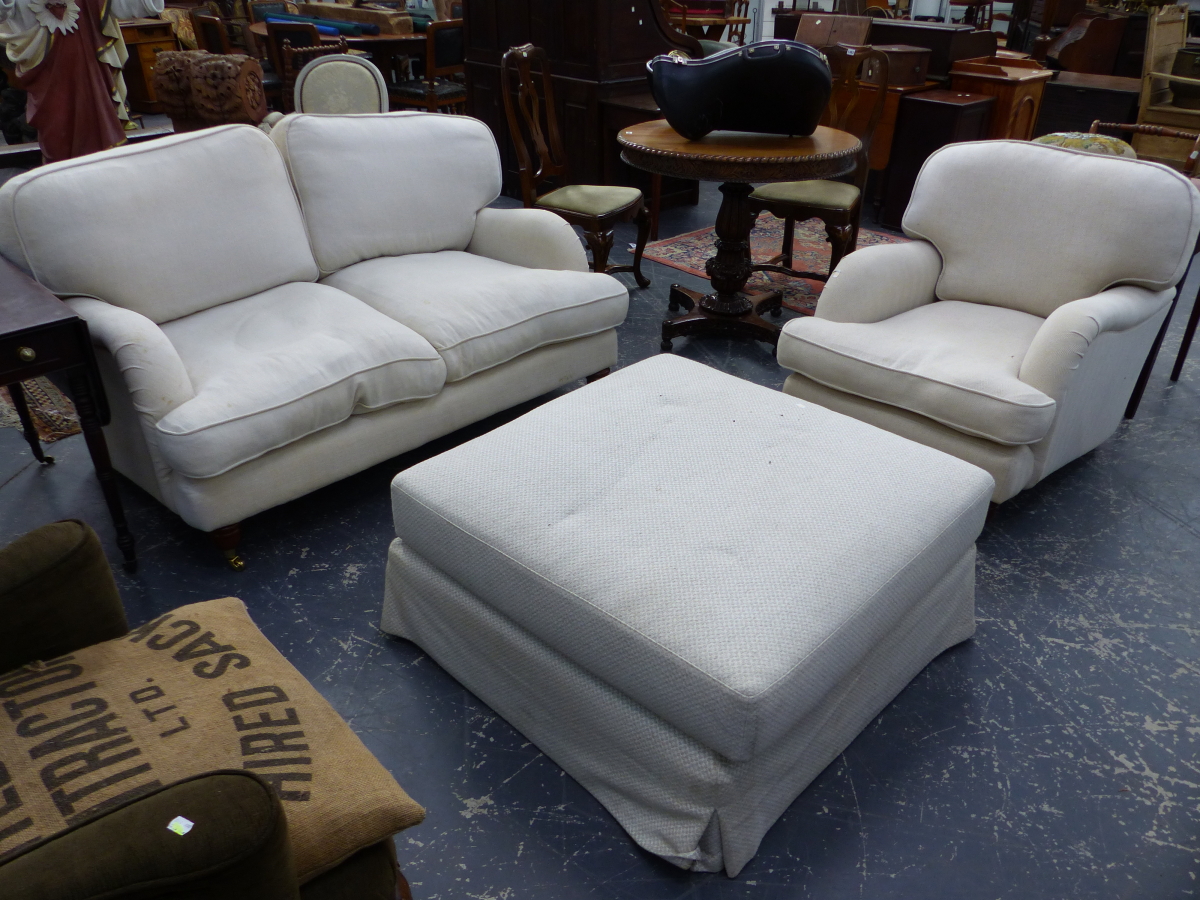 A MODERN HOWARD STYLE TWO SEATER SETTEE, A SIMILAR DEEP SEAT ARMCHAIR AND A LARGE FOOTSTOOL. (3)