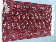 A TEKKE BOKHARA RUG. 120 x 83cms TOGETHER WITH ANOTHER SIMILAR RUG.
