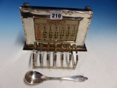 A SILVER FRAMED CALENDAR, BIRMINGHAM 1931. W 20.5cms. A SEVEN BAR TOAST RACK BY W G & S,