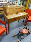 A GORDON RUSSELL WALNUT WRITING TABLE WITH RISING COVER ENCLOSING PIGEON HOLES. 92 x 56 x H.100cms.