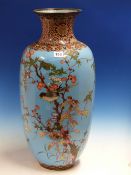 A JAPANESE CLOISONNE VASE WORKED WITH BIRDS AMONGST FLOWERS ON A SKY BLUE GROUND. H.60cms.