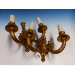 A PAIR OF GILT WOOD TWO BRANCH WALL LIGHTS, THE FLUTED NOZZLES AND ARMS SCROLLING TO THE BASES OF