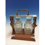 AN OAK TWO BOTTLE TANTALUS WITH CHROME MOUNTS AND CARRYING HANDLE.