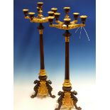 A PAIR OF ORMOLU AND BRONZE SIX LIGHT CANDELABRA, THE REEDED COLUMNS ON THREE PAW FOOTED LEGS. H.