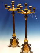 A PAIR OF ORMOLU AND BRONZE SIX LIGHT CANDELABRA, THE REEDED COLUMNS ON THREE PAW FOOTED LEGS. H.