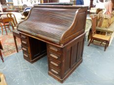 THE ARVON, A MAHOGANY SLATTED ROLL TOP KNEEHOLE DESK, THE KNEEHOLE FLANKED BY FOUR DRAWERS ON PLINTH