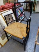 A WILLIAM MORRIS STYLE EBONISED ELBOW CHAIR WITH X-SHAPED BACK RAILS, RUSH SEAT AND CYLINDRICAL