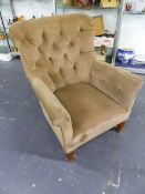 A LATE VICTORIAN BUTTON BACK ARMCHAIR IN MUSHROOM UPHOLSTERY, STAMPED SADGROVE AND CO.