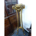 A NEO CLASSICAL STYLE GILTWOOD TORCHERE STAND WITH RAMS HEAD MASKED DECORATION. H.133cms.