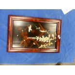 A JAPANESE RED FRAMED BLACK LACQUER PANEL INLAID WITH A BIRD AND BUTTERFLY BY FLOWERING WISTERIA