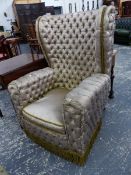 AN UNUSUAL ANTIQUE WING BACK ARMCHAIR WITH SILK CLOSE BUTTON UPHOLSTERY.