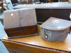 A VICTORIAN OAK STATIONERY BOX, THE SLOPING DOORS ENCLOSING COMPARTMENTS AND TWO INKWELLS. W