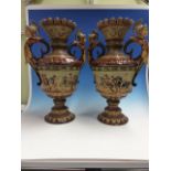 A PAIR OF SCHILLER AND SONS MAJOLICA TWO HANDLED BALUSTER VASES DECORATED IN RELIEF WITH ROMAN