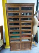 AN OAK SHOP DISPLAY CABINET OF TWO BANKS OF GLASS FRONTED DRAWERS ABOVE SLIDING DOORS. W 92.5 x D 47