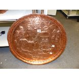 A FAR EASTERN COPPER TRAY WITH RELIEF REPOUSSE DECORATION. Dia.57cms.