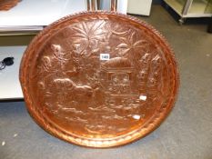 A FAR EASTERN COPPER TRAY WITH RELIEF REPOUSSE DECORATION. Dia.57cms.