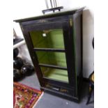 A PAINTED WOOD SIDE CABINET, THE BLACK RECTANGULAR TOP WITH GREEN EDGE FLORAL SPANDRELS AND WHITE