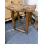 A CHINESE RUSTIC ELM JOINT STOOL WITH BOWED RECTANGULAR SEAT, THE FOUR ROUNDED SQUARE SECTIONED LEGS