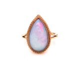 A 9ct GOLD OPAL DOUBLET PEAR CUT CABOCHON RING IN A RUBOVER BEAD AND ROPE SETTING. FINGER SIZE P,