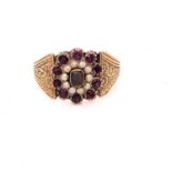 AN ANTIQUE SEED PEARL AND GEMSTONE CLUSTER RING. THE CLUSTER JOINED TO WIDE SET SCROLL ENGRAVED