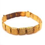 A VICTORIAN GOLD PANEL BRACELET WITH HEART CHARM AND TWO INTEGRAL CLASPS, EACH PANEL WITH FOLIATE