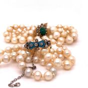 A ROW OF GRADUATED CULTURED PEARLS INTERSPERSED WITH PEARL RONDELS FITTED WITH AN TURQUOISE ENAMEL