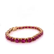 A 14ct OVAL CUT CLAW SET RUBY BRACELET. LENGTH 18cms, GROSS WEIGHT 17.5grms.