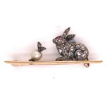 AN ANTIQUE DIAMOND PAVE SET CROUCHING RABBIT WITH A GEM SET EYE SEATED BEFORE A PEARL AND DIAMOND