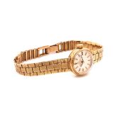 A LADIES 9ct GOLD OMEGA BRACELET WATCH, WHITE DIAL AND GOLD BATONS COMPLETE WITH PURCHASE RECEIPT