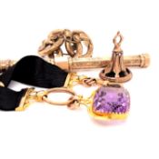 AN AMETHYST FOB CASED IN 9ct GOLD ON A BLACK RIBBON WATCH CHAIN, WITH GOLD FITTINGS, TOGETHER WITH