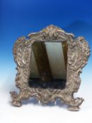 A CONTINENTAL SILVER MOUNTED RECTANGULAR MIRROR, THE OVAL AT THE TOP OF THE ROCOCO FRAME DATED 15