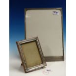 TWO HALLMARKED SILVER PHOTO FRAMES. 32cms X 23cms, AND 16.5cms X 12.5cms.