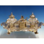 A GOOD VICTORIAN HALLMARKED SILVER DESK STAND WITH TWIN SILVER LIDDED GLASS WELLS CENTERED BY A