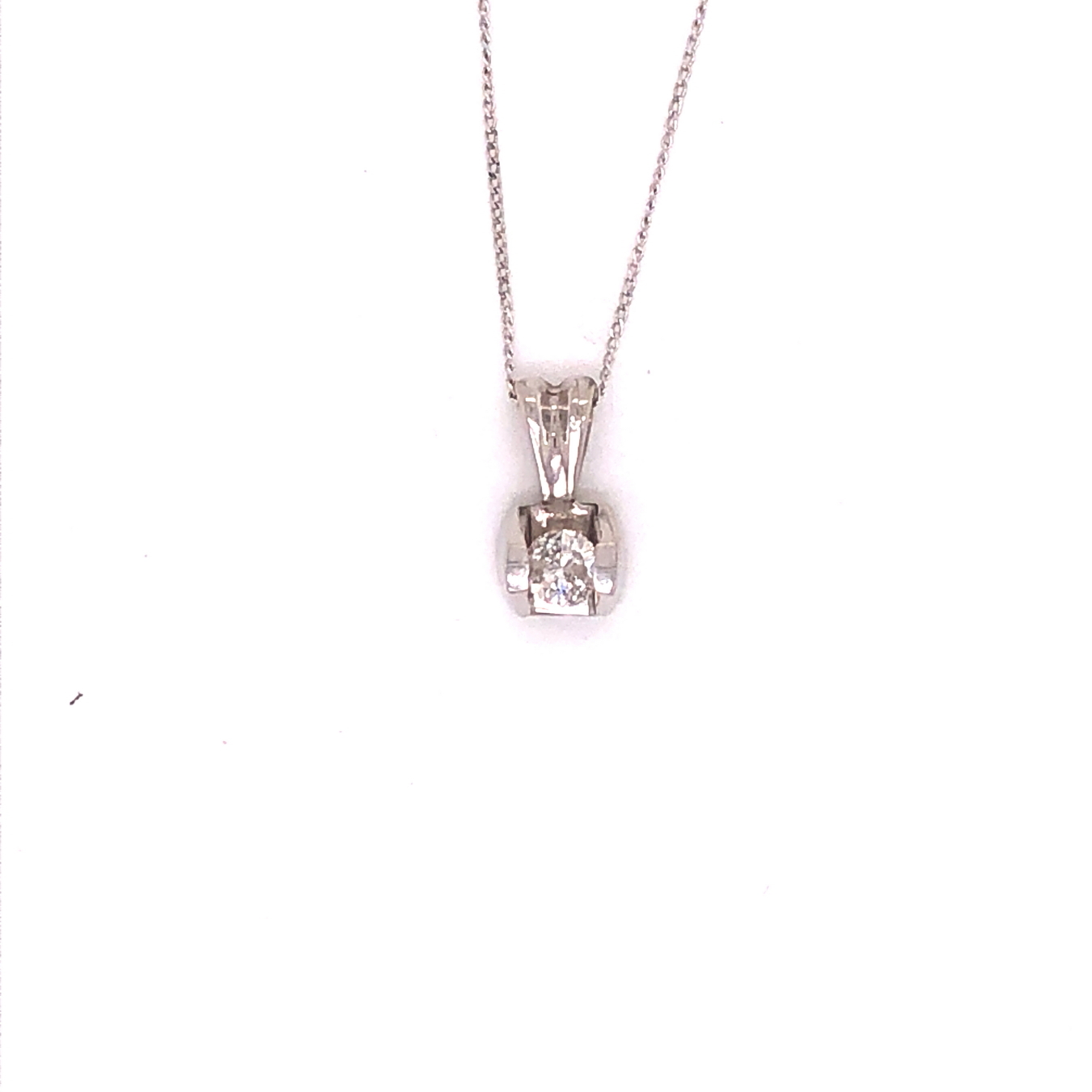 A 9ct WHITE GOLD HALLMARKED DIAMOND SINGLE STONE PENDANT IN A BAR TENSION SETTING, SUSPENDED ON A