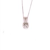 A 9ct WHITE GOLD HALLMARKED DIAMOND SINGLE STONE PENDANT IN A BAR TENSION SETTING, SUSPENDED ON A