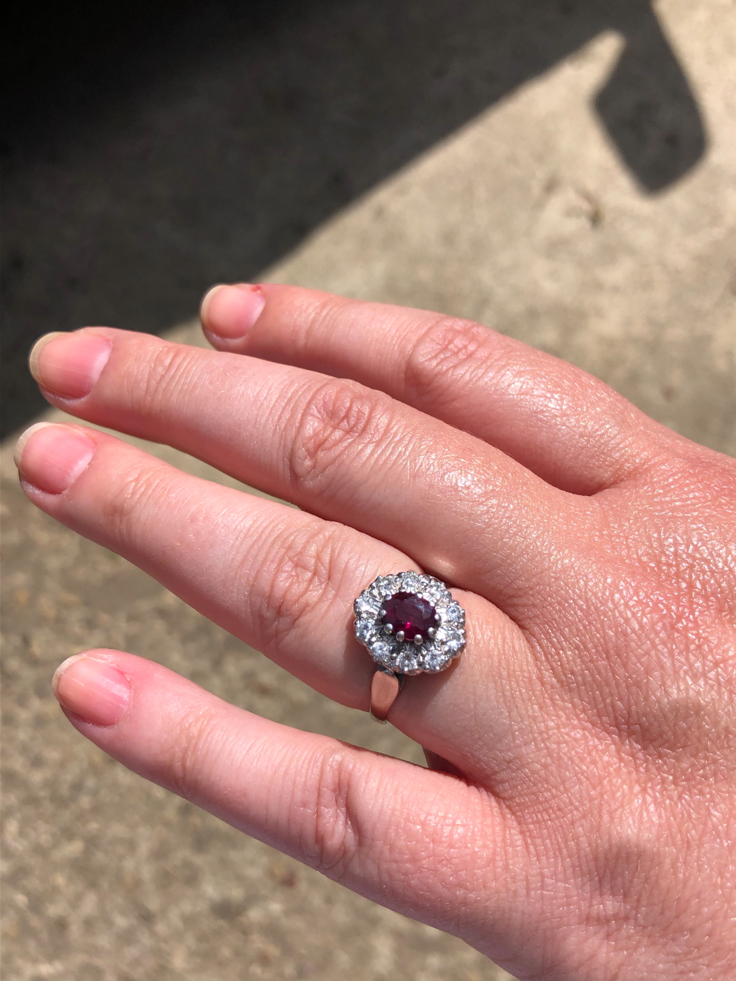 AN 18ct WHITE GOLD RUBY AND DIAMOND CLUSTER RING. THE OVAL CLAW SET RUBY SURROUNDED BY A CLUSTER - Image 15 of 18