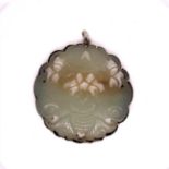AN ORIENTAL JADE AND SILVER MOUNTED CARVED DISC DECORATED WITH BUTTERFLY. DIAMETER 6cms, GROSS