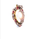 AN ANTIQUE GOLD, ROCK CRYSTAL, DIAMOND AND RUBY MEMORIAL PENDANT CONTAINING A LOCK OF HAIR, WITH A
