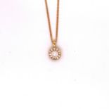 AN 18ct YELLOW GOLD DIAMOND AND PEARL PENDANT. THE CULTURED PEARL SURROUNDED BY A HALO OF