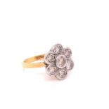 AN 18ct YELLOW GOLD SEVEN STONE RUB OVER SET DIAMOND DAISY CLUSTER RING. APPROIMATE ESTIMATED
