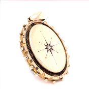 AN ANTIQUE VICTORIAN OVAL GOLD LOCKET WITH AN OLD CUT DIAMOND IN A STARBURST SETTING AND AN ORNATE