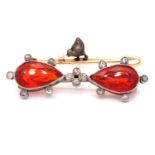 A FIRE OPAL AND DIAMOND BROOCH, THE TWO MATCHING FIRE OPALS ARE PEAR CUT IN A RUBOVER SETTING