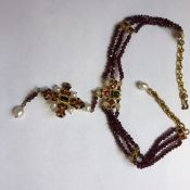 AN ITALIAN DESIGNER PERCOSSI PAPI NECKLACE VARIOUSLY SET WITH GARNETS, PEARLS AND ENAMELLED