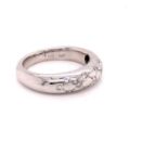 AN 18ct WHITE GOLD AND DIAMOND FLUSH SET DIAMOND UNDER CARVED BEZEL BAND. FINGER SIZE N. APPROX